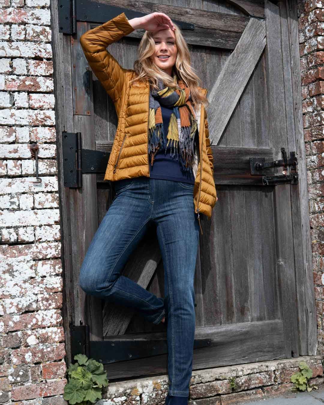 Model wearing autumn gold Frandsen Jacket and navy Robell Jeans