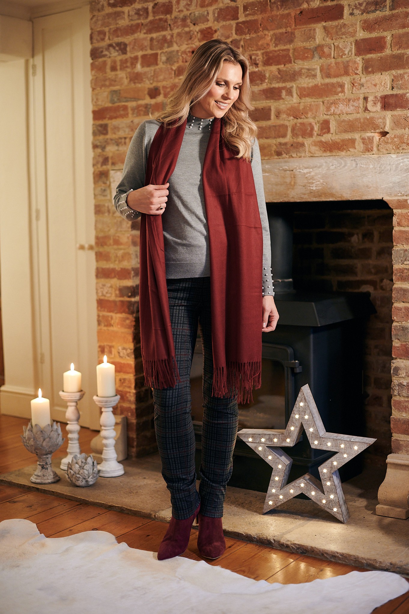 Christmas outfit by fireplace in Robell Brodie Check trouser and Turtle Neck Jumper